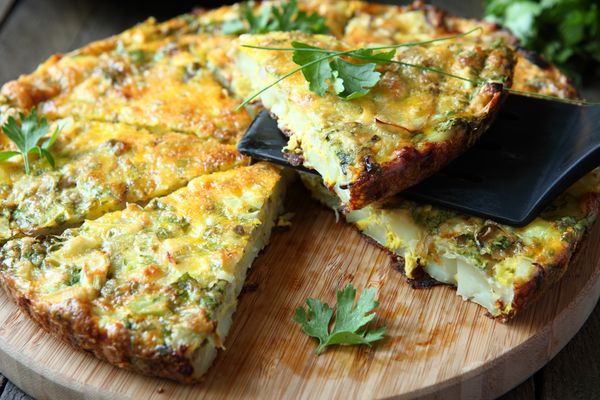 A close-up of a frittata on a cutting board